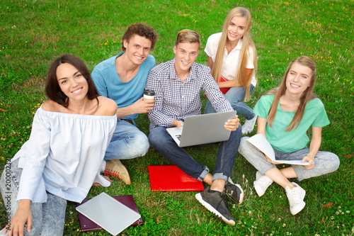Group of young students sit...