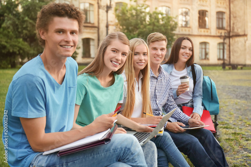 Group of young students sit...