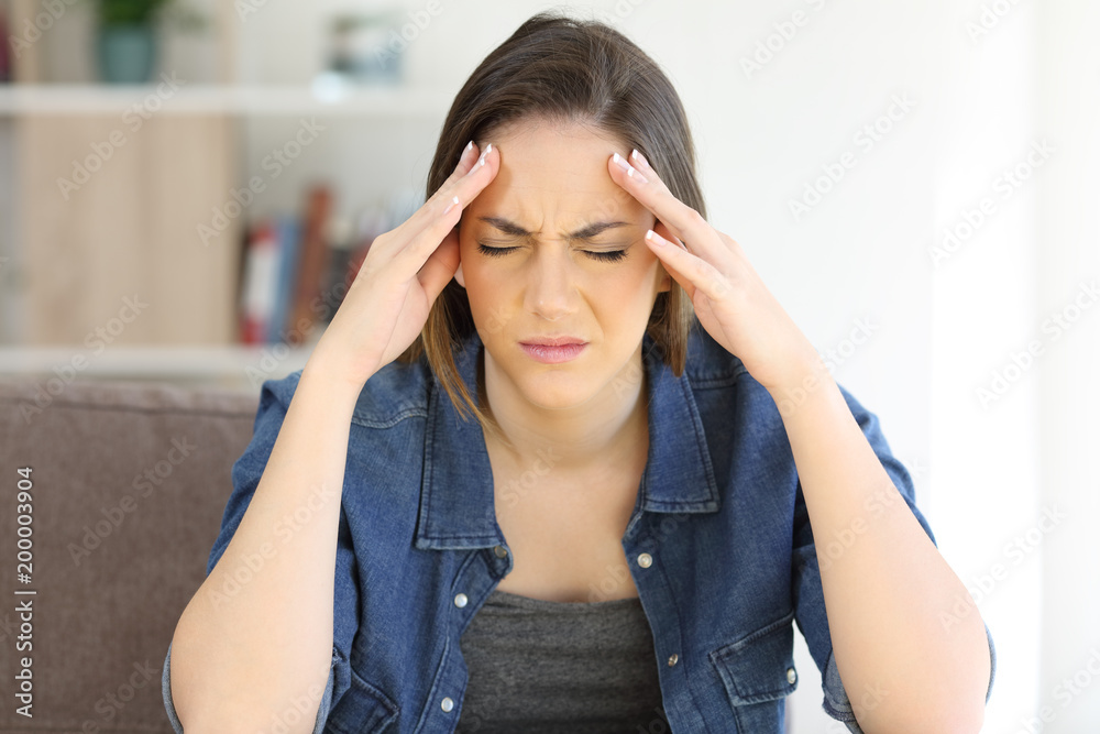 Woman complaining suffering migraine at home Woman complaining suffering migraine at home