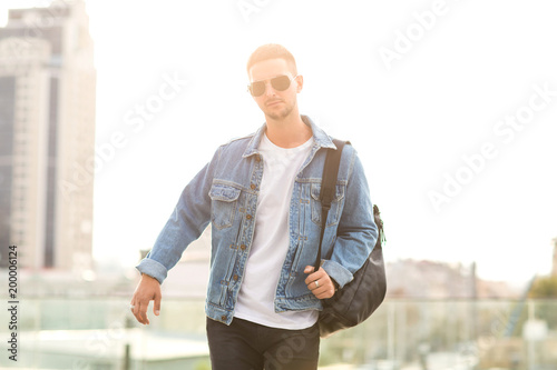 fashion guy posing in sunglasses on sunset