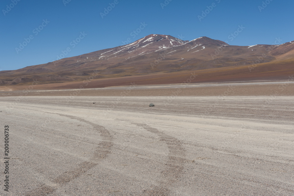 Unpaved Road in Altiplano of the Siloli desert, part of the Reserva Eduardo Avaroa, Bolivia - at an altitude of 4600m near the border of Chile and the Atacama desert, South America