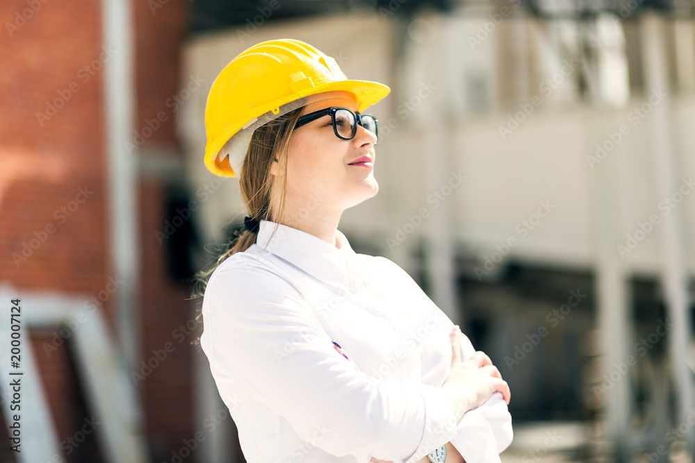 Portrait female engineer posing with arms crossed Portrait female engineer posing with arms crossed