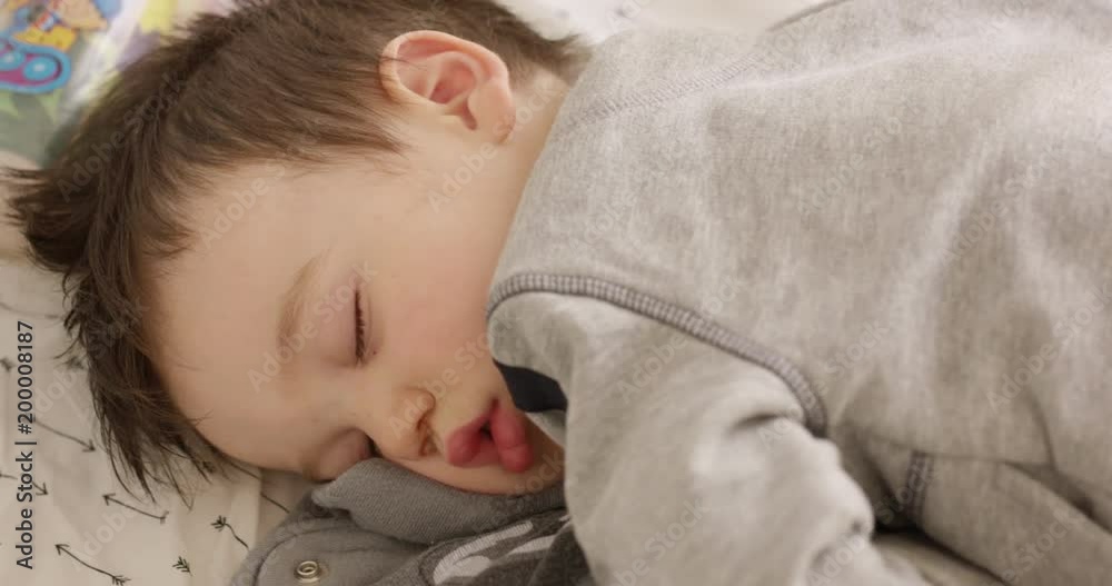 Young boy sleeping in crib - close up on face from above Young boy sleeping in crib - close up on face from above
