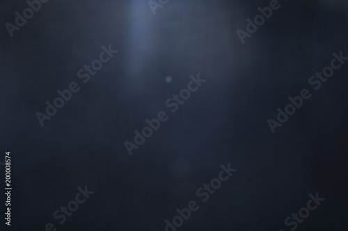 A thin haze of fog hangs over the center of a black background