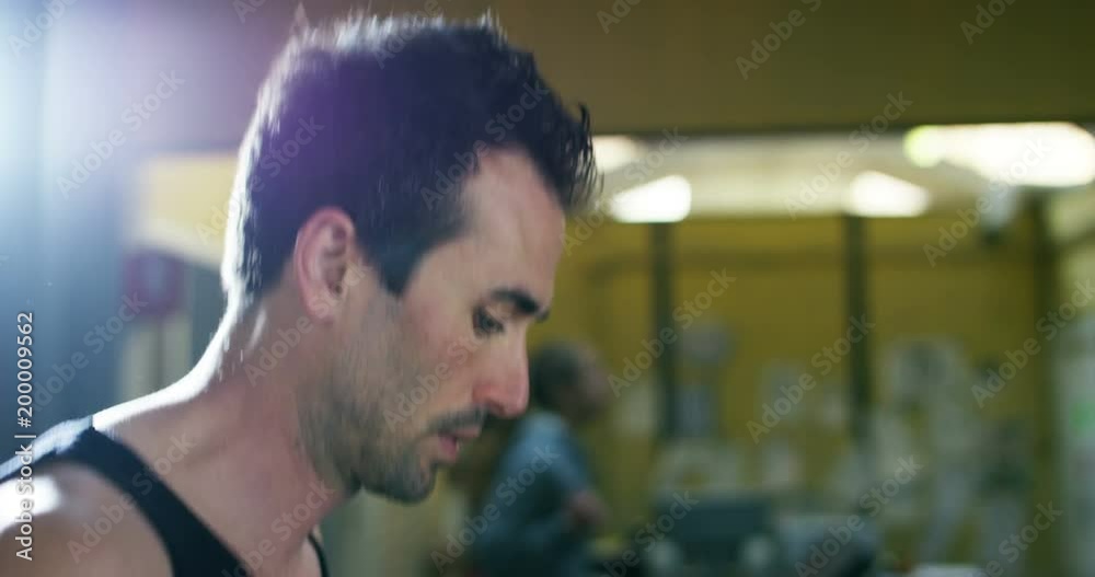 Handsome man with a black tank top, trains at the gym. Concept: Passion for sport, healthy life, gym. Handsome man with a black tank top, trains at the gym. Concept: Passion for sport, healthy life, gym.