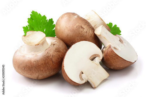Royal Brown champignon with half and parsley leaf isolated on white background