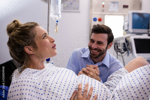 Man comforting pregnant woman during labor