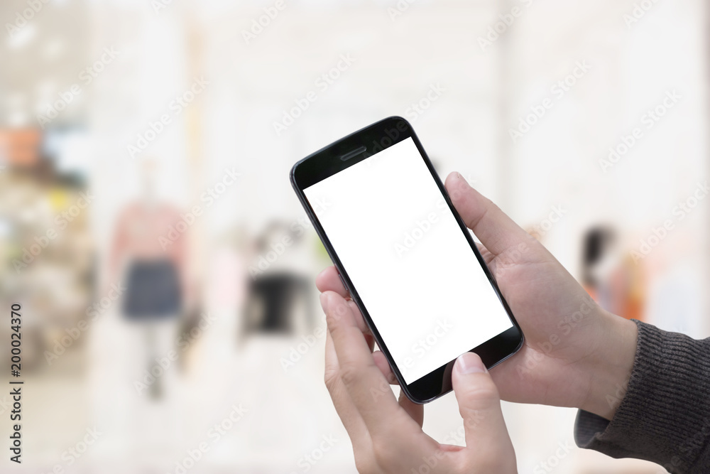 Male hand holding smartphone at office. Blank screen mobile phone for graphic display montage Male hand holding smartphone at office. Blank screen mobile phone for graphic display montage