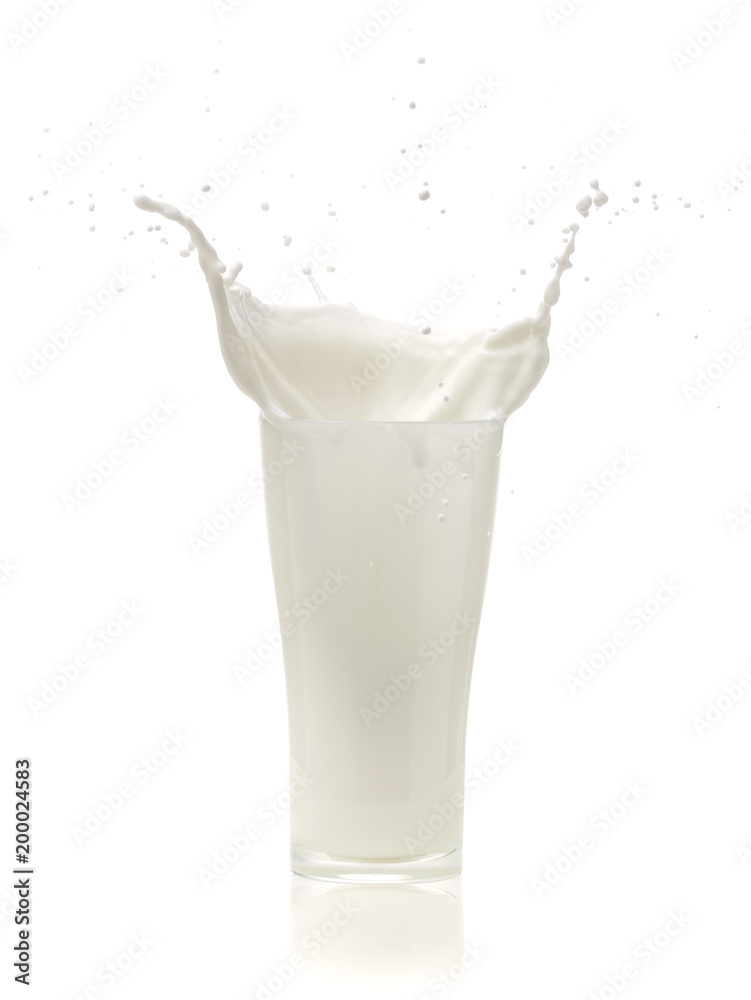 splash of milk in a glass on White background splash of milk in a glass on White background