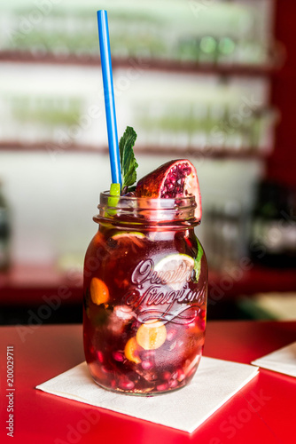 Koblenz, Germany 03.04.18 Homemade lemonade ice tea colorful icetea drink fresh sweet fruits mint glass with straw photo