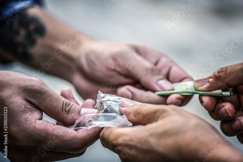 Drug addict buying narcotics and paying