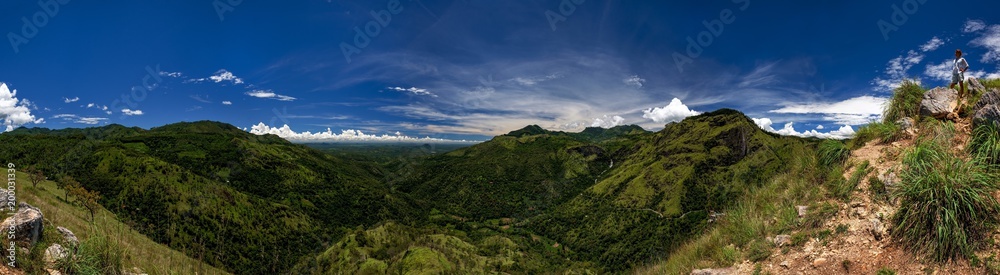Panoramic view from Adam's peak small Ella. Woman standing at touristic viewpoint. Beautiful place of Sri lanka Panoramic view from Adam's peak small Ella. Woman standing at touristic viewpoint. Beautiful place of Sri lanka
