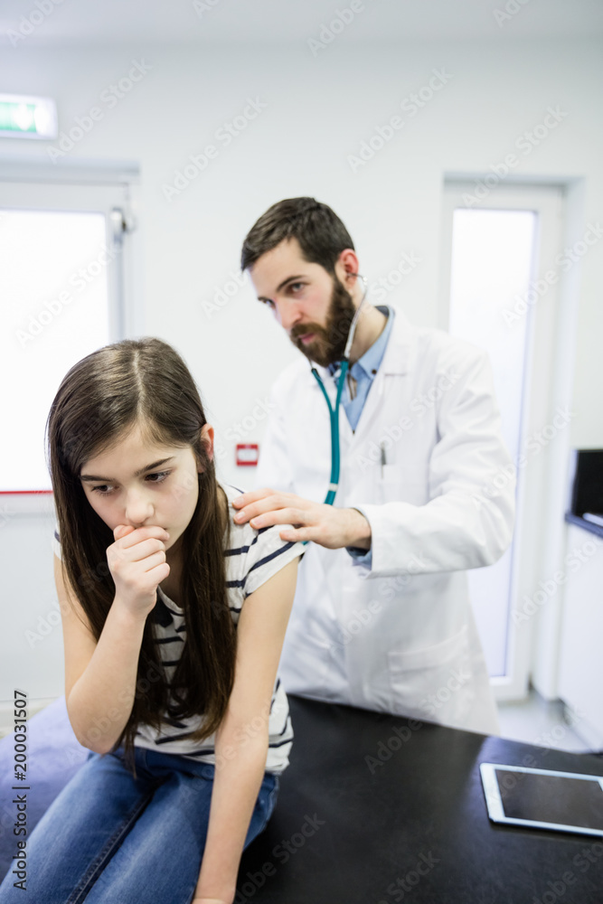 Doctor examining a sick girl Doctor examining a sick girl