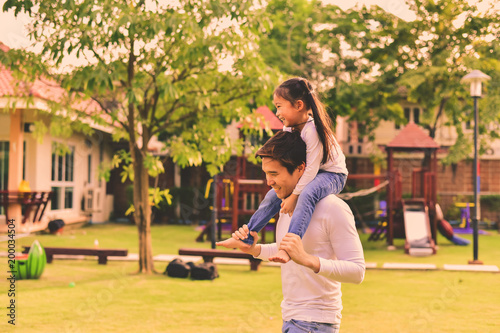 Parents and daughters go for a walk in the park.