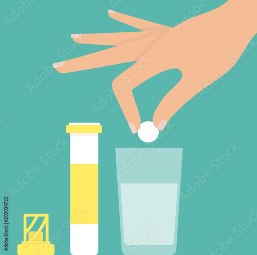 Woman's hand putting effervescent tablet into glass of water