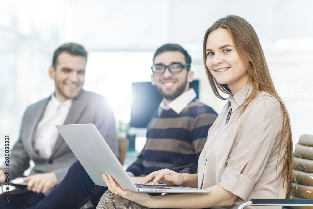 company's employees with a laptop sitting in the lobby of the modern office company's employees with a laptop sitting in the lobby of the modern office