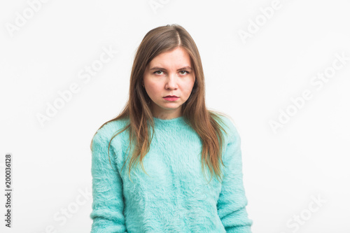 Portrait of angry woman standing on white background © satura_