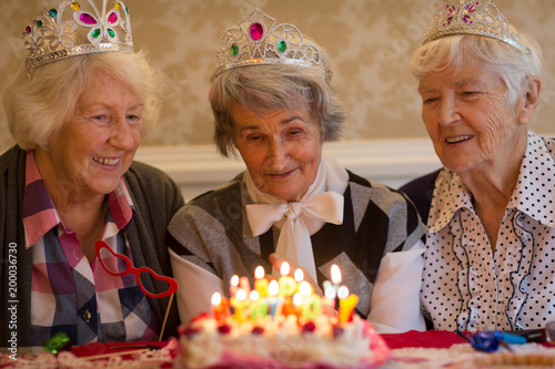 Senior woman celebrating birthday with her friends