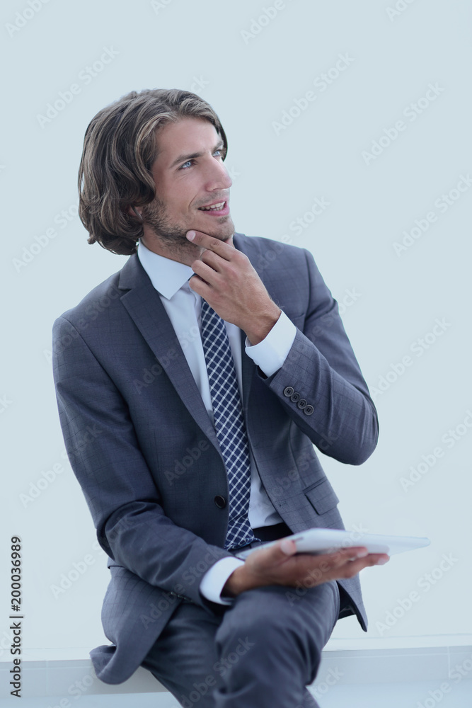 modern businessman with tablet looking at copy space modern businessman with tablet looking at copy space