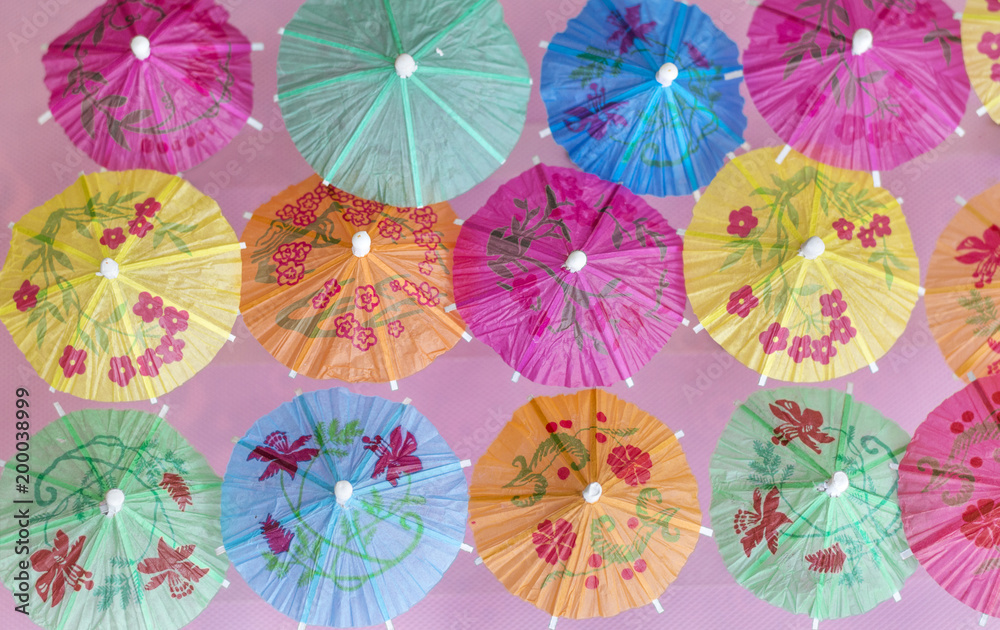 Decorative Cocktail Umbrellas on a Pink Background