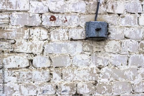 electric switch on an old white brick wall