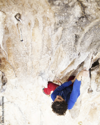 Rock-climbing in Turkey. The climber climbs on the route. Photo from the top.