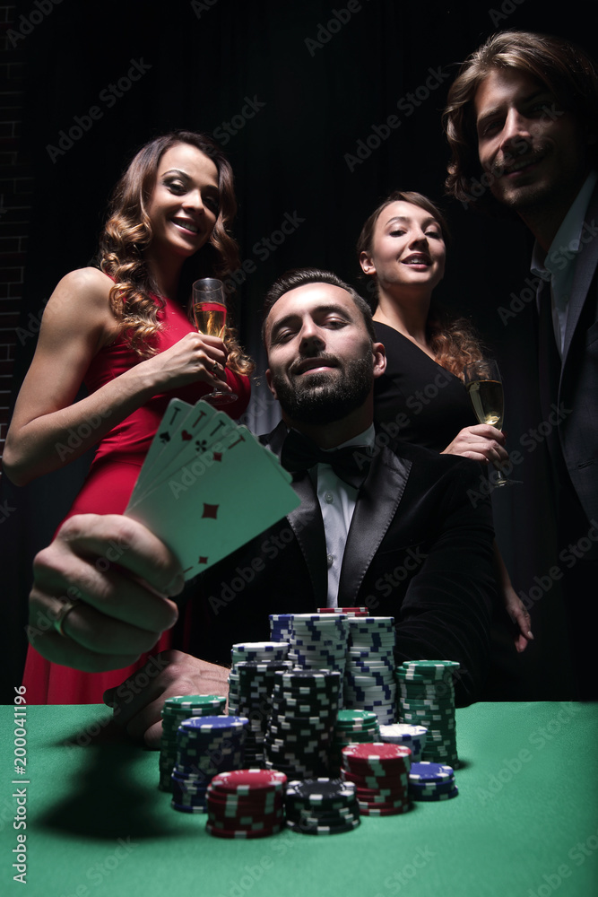 concentrated men and women playing poker in casino concentrated men and women playing poker in casino