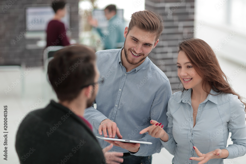 Business team with tablet in office. Business team with tablet in office.