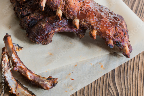 Grilled pork baby ribs with barbecue sauce on backed paper