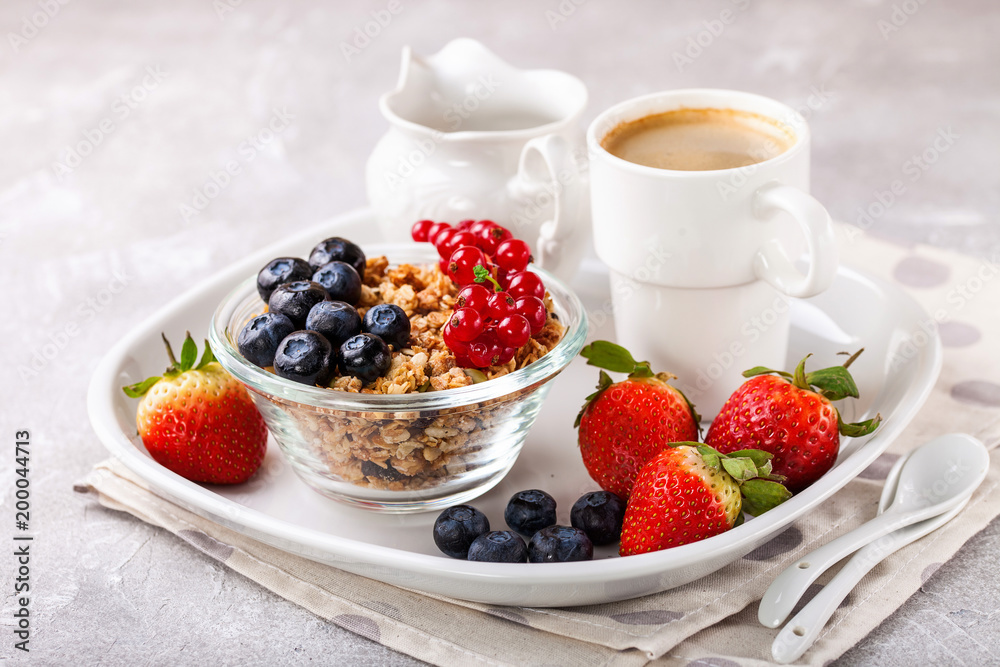 Breakfast - muesli, berries and coffee. Selective focus. Copy space Breakfast - muesli, berries and coffee. Selective focus. Copy space