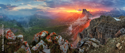 Panorama dramatic sunset in dolomites alp mountain from peak Nuvolau