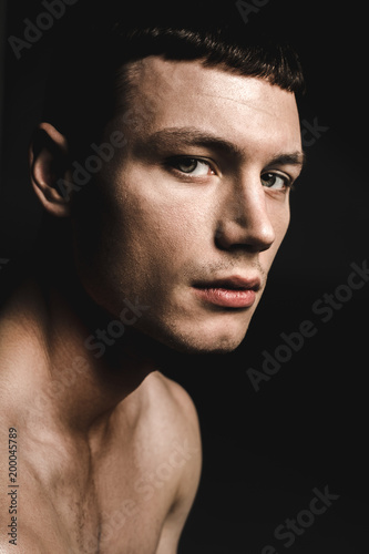 Portrait of young man with attractive body expressing tranquility. Peace of mind concept