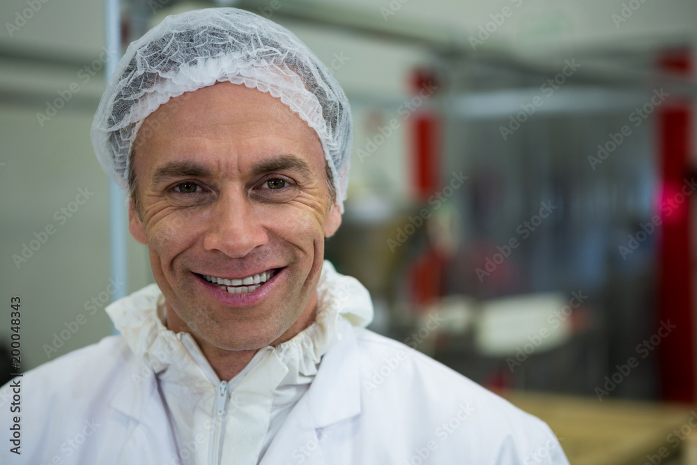 Butcher smiling at meat factory Butcher smiling at meat factory