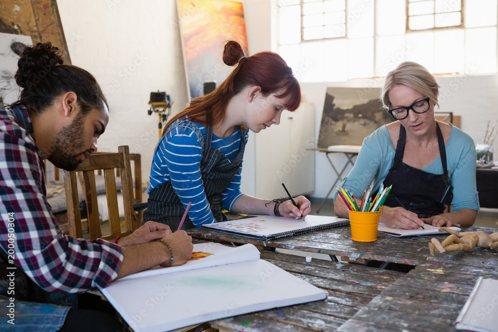 Adult student practicing drawing in art class Adult student practicing drawing in art class