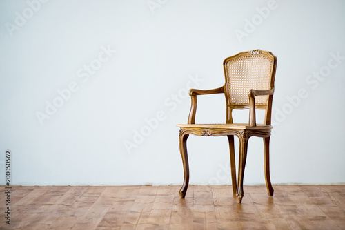 old chair on a gray wall background.