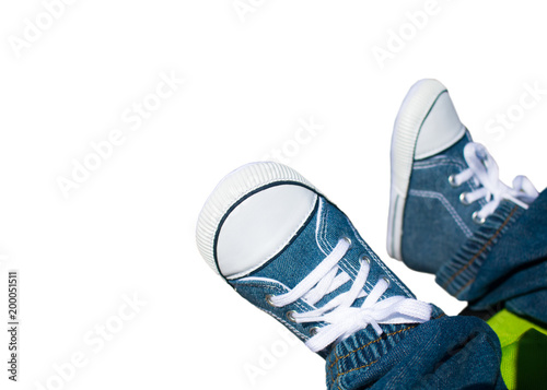 Close-up on child feet with sneakers.