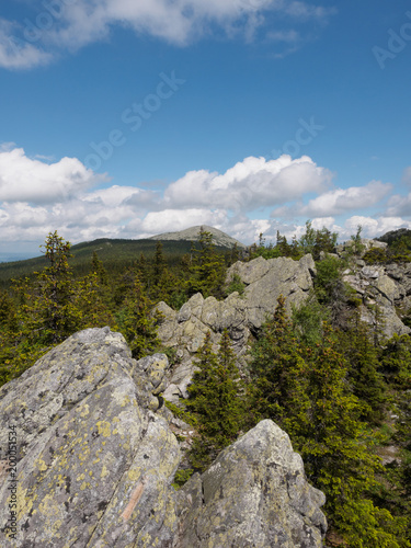 Landscape with rock in forest at summer day. Mountains in Russia.