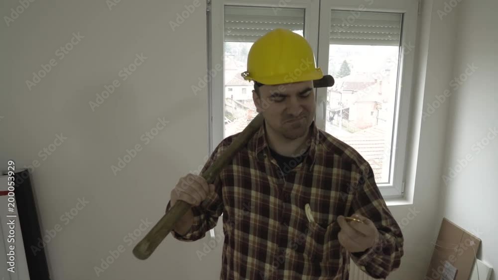Performance of young happy and smiling man with protective helmet and pickax during holding in hand bitcoin, looking in his mining machine, concept cryptocurrency, symbolic shot of positive reactions. Performance of young happy and smiling man with protective helmet and pickax during holding in hand bitcoin, looking in his mining machine, concept cryptocurrency, symbolic shot of positive reactions.