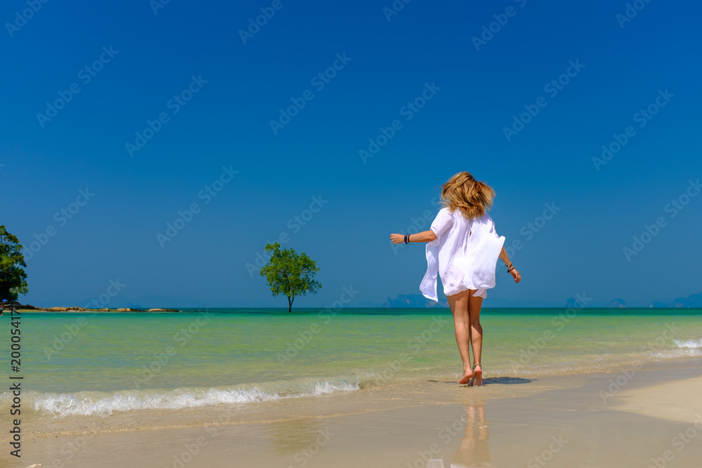 Woman relaxing on the beach in Krabi Thailand Woman relaxing on the beach in Krabi Thailand
