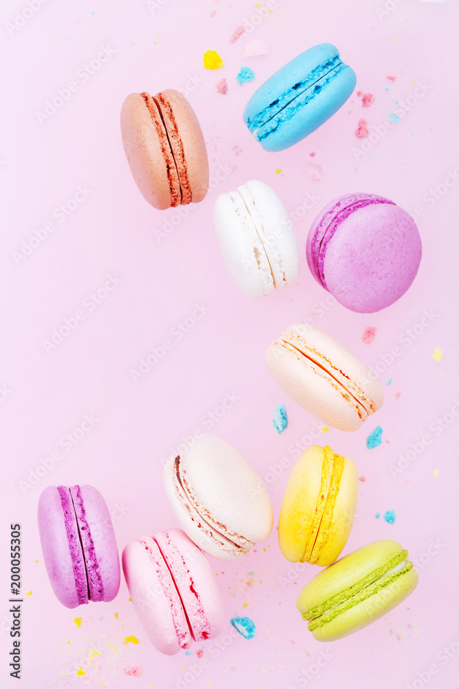Flying cake macaron or macaroon on pink pastel background. Colorful almond cookies on dessert. Flying cake macaron or macaroon on pink pastel background. Colorful almond cookies on dessert.