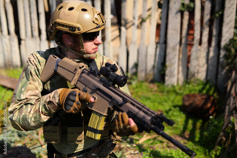 Airsoft player, soldier with weapon Airsoft player, soldier with weapon