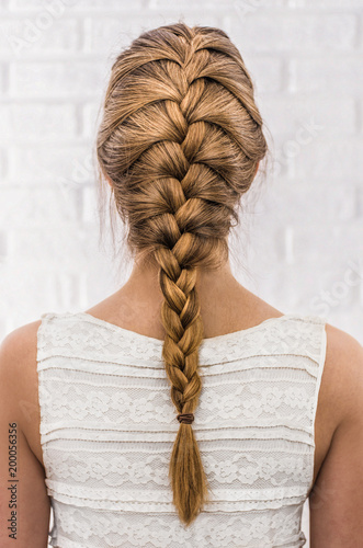 Obraz na płótnie Head of a young woman from behind. Rear view braid
