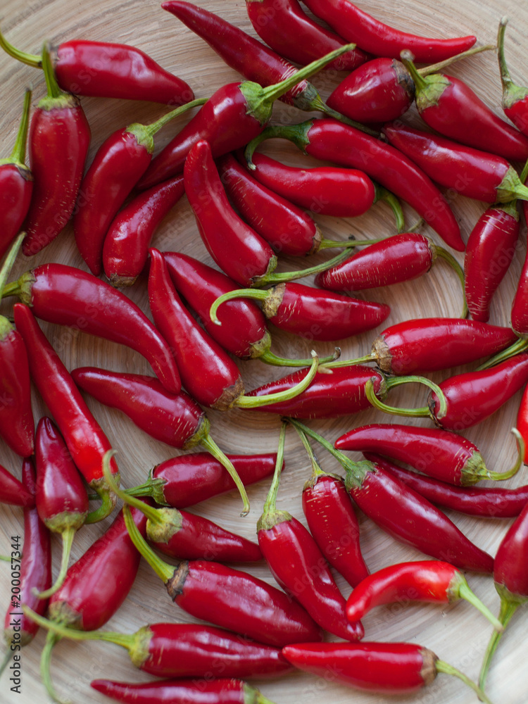 Beautiful red peppers or chilies on wooden tale or chopping board background, Fresh chilies from farm and sunshine, Side view of red peppers, Red hot chili pepper Beautiful red peppers or chilies on wooden tale or chopping board background, Fresh chilies from farm and sunshine, Side view of red peppers, Red hot chili pepper