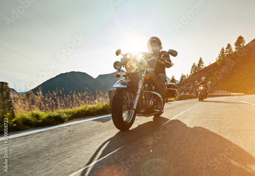 Motorcycle drivers riding in Alpine highway on famous Hochalpenstrasse, Austria, Europe.