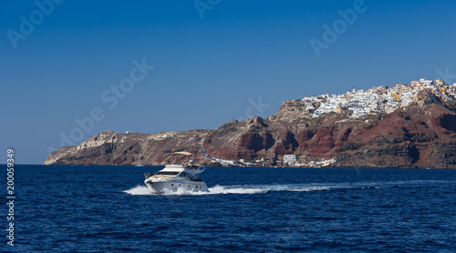 Boat in deep blue water, Santorini, Greece.