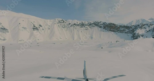 Aerial view The skiers go to the helicopter in the snowy mountains photo