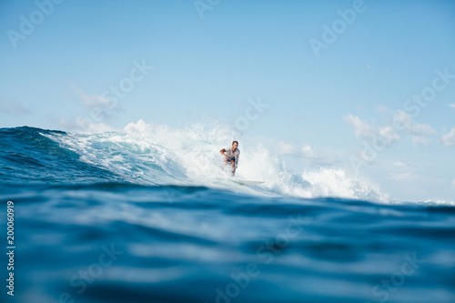 handsome young man having fun on surfboard on sunny day