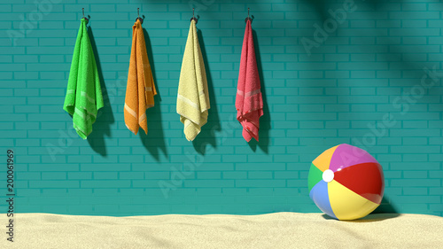 Photos Four colorful fluffy towels hanging on the turquoise brick-like wall with a beac
