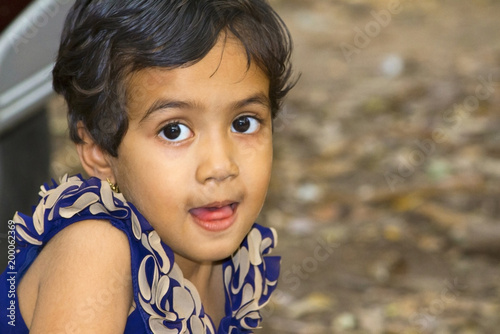 Close up of little Indian girl with her mouth open, Empress garden, Pune photo