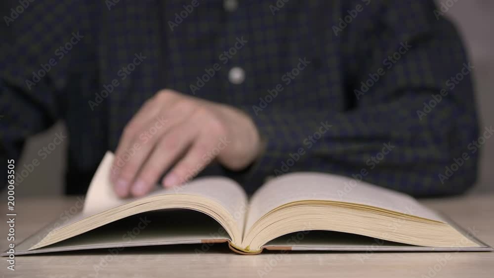 Person browsing pages of old book, Male hand brows book pages. Person browsing pages of old book, Male hand brows book pages.